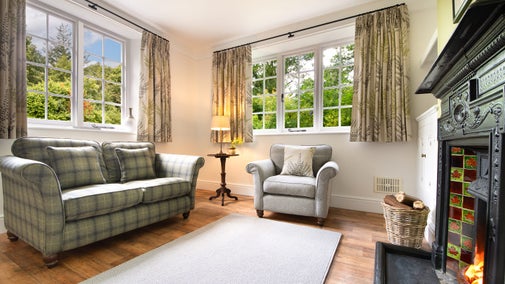 The sitting room with open fire at Elbow Cottage, Cornwall
